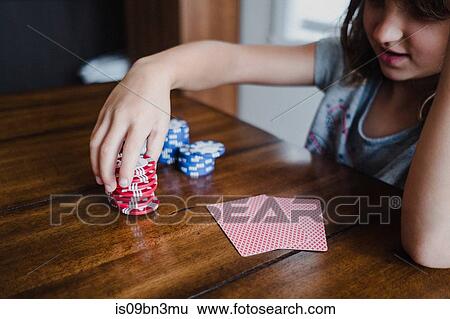Girl playing cards at table, stacking gambling chips, close up View Large Photo Image Stock Photograph - Girl playing cards at table, stacking gambling chips, close up. Fotosearch