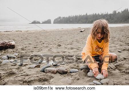 Girl playing on beach, Tofino, Canada View Large Photo Image Stock Photo - Girl playing on beach, Tofino, Canada. Fotosearch