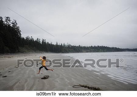 Girl playing on beach, Tofino, Canada View Large Photo Image Stock Photography - Girl playing on beach, Tofino, Canada. Fotosearch