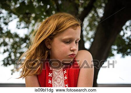 Girl puckering by tree View Large Photo Image Stock Image - Girl puckering by tree. Fotosearch