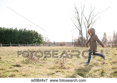 Stock Photo - Girl running in field. Fotosearch