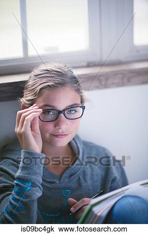 Girl sitting on floor doing homework, portrait View Large Photo Image Stock Image - Girl sitting on floor doing homework, portrait. Fotosearch