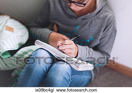 Girl sitting on floor writing up homework View Large Photo Image Stock Image - Girl sitting on floor writing up homework. Fotosearch