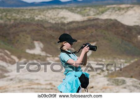 Girl taking photograph of view, Red Rock Canyon, Cantil, California, United States View Large Photo Image Stock Image - Girl taking photograph of view, Red Rock Canyon, Cantil, California, United States. Fotosearch