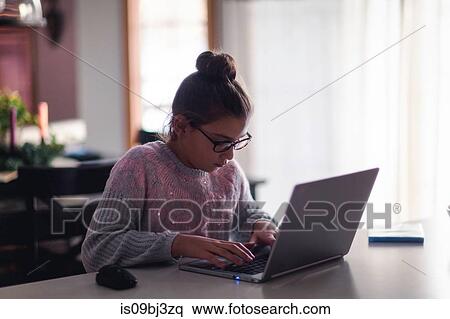 Girl using laptop at home View Large Photo Image Stock Photography - Girl using laptop at home. Fotosearch
