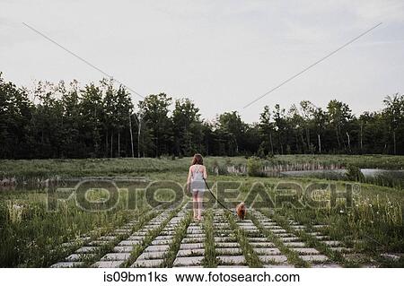Stock Photograph - Girl walking puppy. Fotosearch