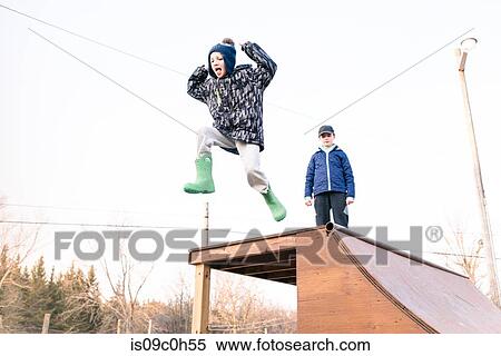 Girl watching brother jump from top of skateboard ramp View Large Photo Image Stock Photography - Girl watching brother jump from top of skateboard ramp. Fotosearch