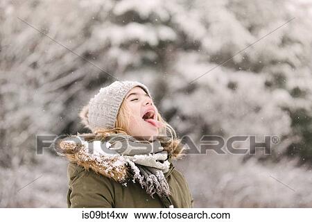 Girl with mouth open waiting for snow View Large Photo Image Stock Photo - Girl with mouth open waiting for snow. Fotosearch
