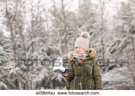 Girl with snow ball in winter landscape View Large Photo Image Stock Photograph - Girl with snow ball in winter landscape. Fotosearch