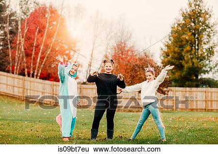 Stock Photograph - Girls in halloween costume posing in park. Fotosearch