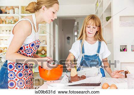 Girls preparing chocolate brownies in kitchen View Large Photo Image Stock Image - Girls preparing chocolate brownies in kitchen. Fotosearch