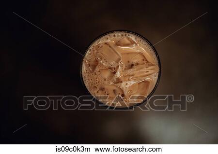 Glass of iced coffee on cafe table, overhead view View Large Photo Image Picture - Glass of iced coffee on cafe table, overhead view. Fotosearch