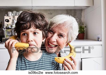 Grandmother and grandson fooling around, using bananas as telephones, laughing View Large Photo Image Stock Image - Grandmother and grandson fooling around, using bananas as telephones, laughing. Fotosearch