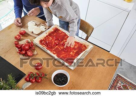 Grandmother and grandson making pizza in kitchen, elevated view View Large Photo Image Stock Image - Grandmother and grandson making pizza in kitchen, elevated view. Fotosearch