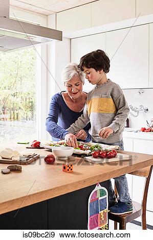 Grandmother and grandson, making pizza together View Large Photo Image Stock Photo - Grandmother and grandson, making pizza together. Fotosearch