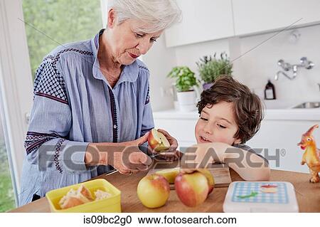 Grandmother and grandson preparing food in kitchen View Large Photo Image Stock Image - Grandmother and grandson preparing food in kitchen. Fotosearch