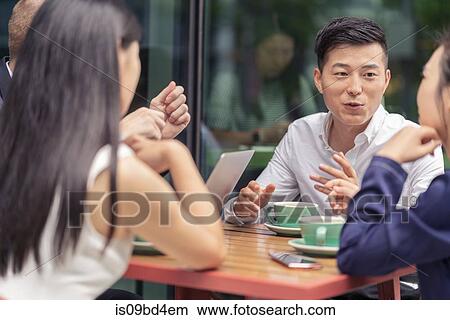 Group of businesspeople, having meeting at cafe, outdoors View Large Photo Image Picture - Group of businesspeople, having meeting at cafe, outdoors. Fotosearch