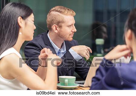 Group of businesspeople, having meeting at cafe, outdoors View Large Photo Image Stock Image - Group of businesspeople, having meeting at cafe, outdoors. Fotosearch