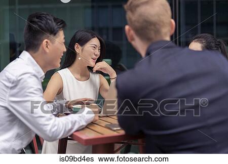 Group of businesspeople, having meeting at cafe, outdoors View Large Photo Image Stock Photograph - Group of businesspeople, having meeting at cafe, outdoors. Fotosearch