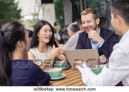 Group of businesspeople, having meeting at cafe, using laptop, outdoors View Large Photo Image Stock Photography - Group of businesspeople, having meeting at cafe, using laptop, outdoors. Fotosearch