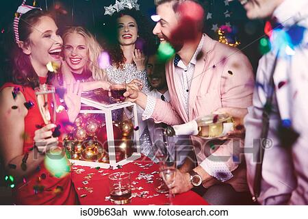 Group of friends at party, fooling around, pouring drinks View Large Photo Image Stock Image - Group of friends at party, fooling around, pouring drinks. Fotosearch