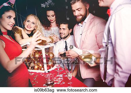 Group of friends at party, pouring drinks View Large Photo Image Stock Image - Group of friends at party, pouring drinks. Fotosearch