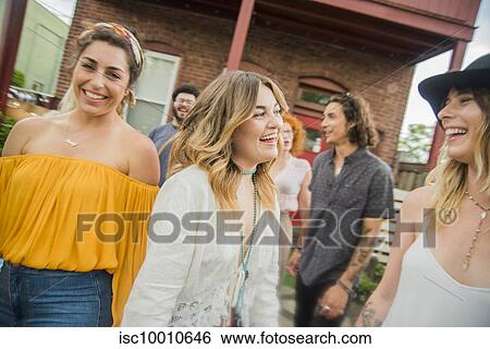 Group of friends laughing and chatting at community garden party View Large Photo Image Stock Photograph - Group of friends laughing and chatting at community garden party. Fotosearch