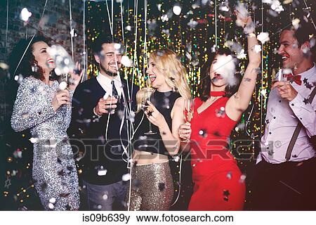 Group of people dancing and having fun at party, glitter falling through air View Large Photo Image Stock Photo - Group of people dancing and having fun at party, glitter falling through air. Fotosearch