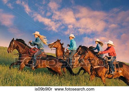 Group of people riding horses in field View Large Photo Image Stock Photography - Group of people riding horses in field. Fotosearch