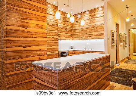 Gumwood cabinets and island, pure white quartz countertop in kitchen View Large Photo Image Stock Image - Gumwood cabinets and island, pure white quartz countertop in kitchen. Fotosearch