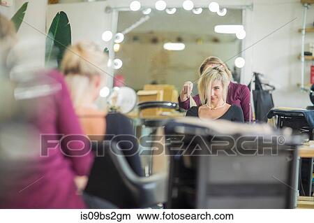 Hairdresser styling customer's hair in salon View Large Photo Image Picture - Hairdresser styling customer's hair in salon. Fotosearch