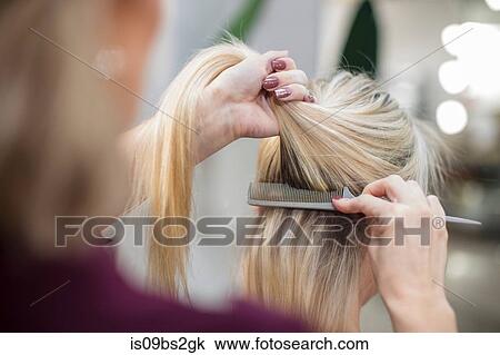 Hairdresser styling customer's hair in salon View Large Photo Image Stock Image - Hairdresser styling customer's hair in salon. Fotosearch