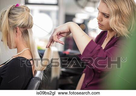 Hairdresser styling customer's hair in salon View Large Photo Image Stock Image - Hairdresser styling customer's hair in salon. Fotosearch