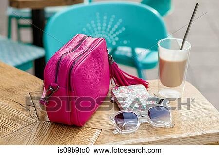 Handbag, sunglasses and latte on sidewalk cafe table View Large Photo Image Stock Image - Handbag, sunglasses and latte on sidewalk cafe table. Fotosearch