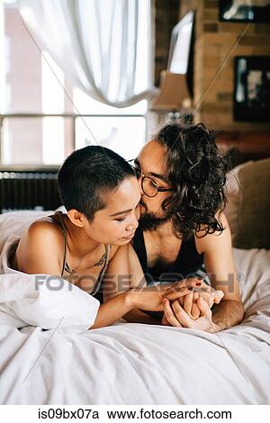 Happy couple under covers in bed View Large Photo Image Stock Image - Happy couple under covers in bed. Fotosearch