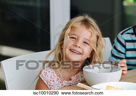 Happy little girl finishing lunch at home View Large Photo Image Stock Image - Happy little girl finishing lunch at home. Fotosearch