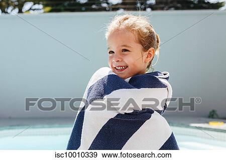 Happy little girl wrapped in towel by swimming pool View Large Photo Image Stock Photo - Happy little girl wrapped in towel by swimming pool. Fotosearch