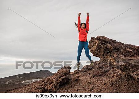 Happy woman at summit of mountain, Haleakala National Park, Maui, Hawaii View Large Photo Image Picture - Happy woman at summit of mountain, Haleakala National Park, Maui, Hawaii. Fotosearch