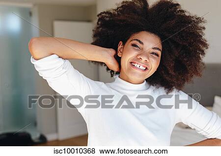 Happy young woman with hand in afro hair in bedroom, head and shoulder portrait View Large Photo Image Stock Photo - Happy young woman with hand in afro hair in bedroom, head and shoulder portrait. Fotosearch