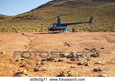 Helicopter and pilot in rural landscape, Cape Town, Western Cape, South Africa View Large Photo Image Stock Image - Helicopter and pilot in rural landscape, Cape Town, Western Cape, South Africa. Fotosearch