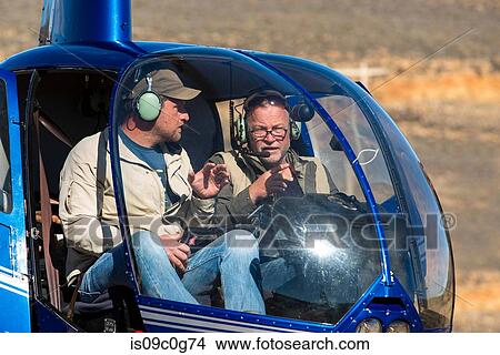 Helicopter and pilots on ground in rural landscape, Cape Town, Western Cape, South Africa View Large Photo Image Picture - Helicopter and pilots on ground in rural landscape, Cape Town, Western Cape, South Africa. Fotosearch