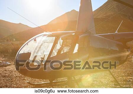 Helicopter in sunlit arid rural landscape, Cape Town, Western Cape, South Africa View Large Photo Image Stock Photograph - Helicopter in sunlit arid rural landscape, Cape Town, Western Cape, South Africa. Fotosearch
