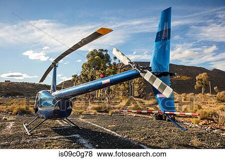 Helicopter on ground in rural landscape, rear view, Cape Town, Western Cape, South Africa View Large Photo Image Stock Photo - Helicopter on ground in rural landscape, rear view, Cape Town, Western Cape, South Africa. Fotosearch