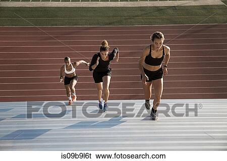 Stock Photograph - High angle view of woman running up steps. Fotosearch