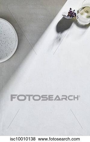 High key still life with glass of white wine and white plate on white table, overhead view View Large Photo Image Stock Photo - High key still life with glass of white wine and white plate on white table, overhead view. Fotosearch