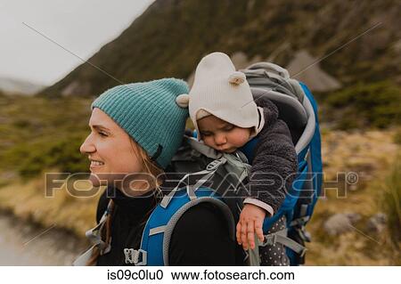 Stock Image - Hiker and baby exploring trail, Wanaka, Taranaki, New Zealand. Fotosearch