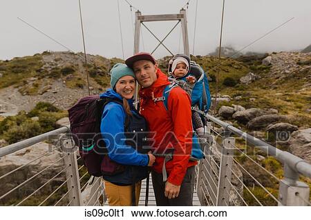 Hiker couple with baby on suspension bridge, Wanaka, Taranaki, New Zealand View Large Photo Image Stock Image - Hiker couple with baby on suspension bridge, Wanaka, Taranaki, New Zealand. Fotosearch