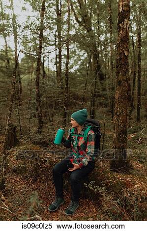 Hiker drinking, enjoying forest, Queenstown, Canterbury, New Zealand View Large Photo Image Stock Photography - Hiker drinking, enjoying forest, Queenstown, Canterbury, New Zealand. Fotosearch