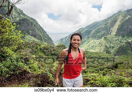 Picture - Hiker enjoying rainforest, Iao Valley, Maui, Hawaii. Fotosearch