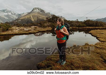 Stock Image - Hiker enjoying scenic lake view, Queenstown, Canterbury, New Zealand. Fotosearch